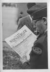 An American correspondent reads the special edition of the Nurnberger newspaper reporting on the sentences meted out by the International Military Tribunal.