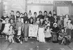 Group portrait of children in a Jewish school in Amsterdam dressed in Purim costumes.