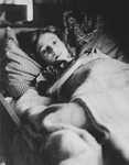 An eleven-year-old Jewish girl lies in bed after her liberation in Bergen-Belsen.
