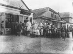 Women and children wait in line outside a soup kitchen in Luboml.