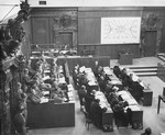 The defendants (left), their lawyers (center), the Military Tribunal I (right), and the prosecution (bottom), listen to the proceedings at a session of the Medical Case (Doctors') Trial in Nuremberg.