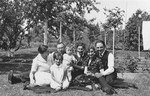 Group portrait of members of a Jewish family in the backyard of their home in Lechenich, Germany.