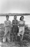 Three Jewish refugee teenagers pose outside in Kenya.