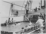 Jewish refugee passengers aboard the MS St. Louis bathe in the swimming pool on the deck of the ship.