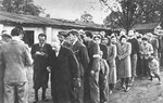 Slovak officials check off the names of Jews who are about to be deported at an assembly point in Zilina, Slovakia.