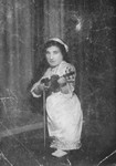 A member of a family of Jewish dwarf entertainers who survived Auschwitz, posing with her violin.
