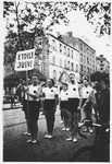 Members of the Jewish sports club, Etoile Juive, salute during a parade through Paris.