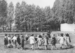 Preschoolers in the Mariendorf displaced persons camp dance in a circle.