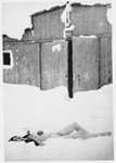 The corpse of a female prisoner lies in the snow outside a barracks in Auschwitz-Birkenau immediately after the liberation.