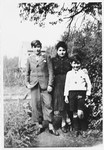 The three older Rotenberg siblings pose in a garden while in hiding in Beligium.
