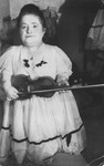 Portrait of Rozika Ovici, a member of a family of Jewish dwarf entertainers who survived Auschwitz, holding her violin.