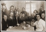 Jewish refugees at a birthday party in Shanghai.  

Albert Jakobsberg and Herbert Feibel are pictured seated fifth and sixth from the left respectively.