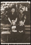 Mania Gryniewicz, right, and her friend, Guta Akierman pose with their children, Adam, right and Ania, during the parents day at a sanatorium for Jewish children in Srodborow, near Warsaw.
