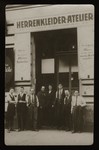 Moritz Wacs (center) and his employees pose in front of his clothing and tailor shop in Vienna.