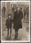 Mania Gryniewicz and her son, Adam, walk in the street in Lodz.