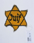 A yellow star of David with the French word for Jew (Juif) printed on it.