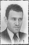 Studio portrait of a member of the administrative staff of the Kielce ghetto Judenrat (Jewish council).