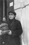 A Jewish man brings loaves of bread to the soup kitchen in the Kielce ghetto.