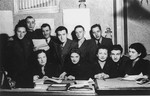 Group portrait of members of the administrative staff of the Kielce ghetto Judenrat (Jewish Council) in their office.