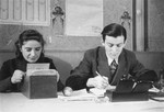 Two members of the ghetto administration at work in the office of the Judenrat in the Kielce ghetto.