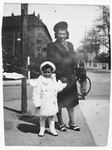 A Jewish mother poses with her daughter on a street corner in the Bispebjerg section of Copenhagen.