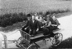 A Jewish family goes for a ride in a horse-drawn wagon.