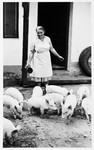 Polish rescuer Manya Blazek feeds the pigs on her farm in Plana nad Luznici, Czechoslovakia.