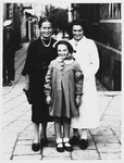 Frieda Fisz (left) poses with a Jewish friend and her daughter on a street in Debica, Poland.