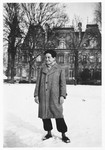 A Jewish refugee youth poses outside in the snow in front of the Chateau Quincy-sur-Senart children's home.