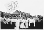 Teenagers from the Beit Yaakov religious school for girls, wave a flag during a Zionist demonstration in the Bergen-Belsen displaced persons camp.