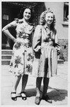 Two sisters pose outside the L1 building in the Bergen-Belsen displaced persons camp.