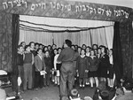 Moshe Zeiri conducts a children's choir during a performance at the Youth Aliyah children's home in Selvino, Italy.
