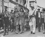 Members of the French resistance lead two women accused of being German sympathizers to the local prison, where their heads will be shaved as punishment for collaboration.