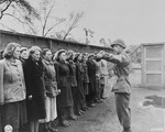 An American officer gives instructions to new German women prisoners upon their arrival at the Recklinghausen internment camp.