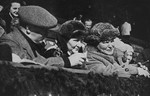 Hermann Goering watches an ice hockey game at the Winter Olympics.