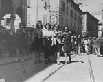 A woman accused of collaborating with the Germans is paraded through the streets of Modena by women members of the resistance.