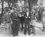 Members of the French resistance in Aix-en-Provence parade a beaten collaborator through the streets of the city.