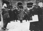 Hungarian soldiers prepare to execute Ferenc Rajniss, the former Minister of Religious Affairs and Education in the Szalasi government, and editor of the right-wing, anti-Semitic journal "Magyar Futar."

Following his activities as the editor of the right-wing, anti-Semitic journal, "Magyar Futar," Ferenc Rajniss served as the Minister for Religious Affairs and Education in the collaborationist government of Ferenc Szalasi.