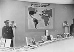 An exhibit of Nazi publications touting the achievements of the Third Reich; including a poster showing countries in which "Mein Kampf" had been translated into the native language.