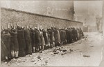 Jews captured by the SS during the suppression of the Warsaw ghetto uprising are lined up against a wall prior to being searched for weapons.