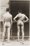 Two residents of the ghetto stripped naked after their capture by the SS.