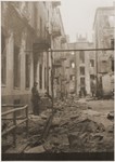 SS troops search ruined buildings for survivors during the suppression of the Warsaw ghetto uprising.