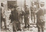 SS assault troops capture two Jewish resistance fighters pulled from a bunker during the suppression of the Warsaw ghetto uprising.