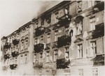 A Jewish man leaps to his death from the top story window of an apartment block during the suppression of the Warsaw ghetto uprising.