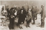 SS troops guard members of the Jewish resistance captured during the suppression of the Warsaw ghetto uprising.