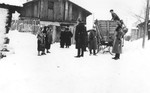 German police stop a group of Jews on a snow covered street in the Zawiercie ghetto.