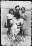 Rina Altbeker poses with her aunt, Ruth Cyprys, and other friends and family at Ruth's summer villa at or near the start of the war.