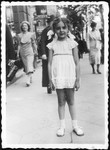 A young Jewish girl poses on a street in prewar Poland.