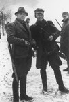 SS officers carry shotguns during a winter hunting trip.