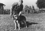 SS officer Karl Hoecker pets his dog, Favorit.